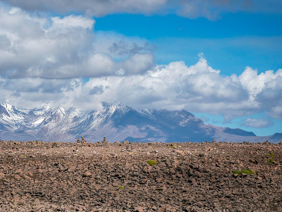 Soil and mountain in the background with clouds in the sky